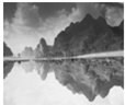 如图所示的四种现象中,由于光的反射形成的是A.墙上的影子B.森林中的光线C.水中山的倒影D.铅笔好像折断了 魔方格